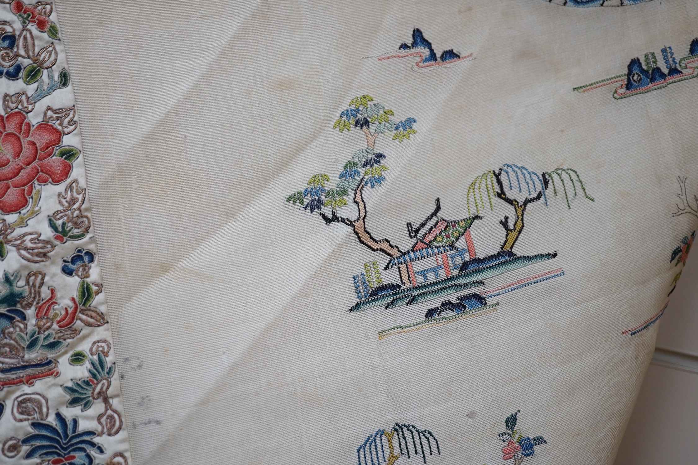 A late 19th/early 20th century Chinese gauze summer robe embroidered with flowers, figures and pagodas, 85cm high